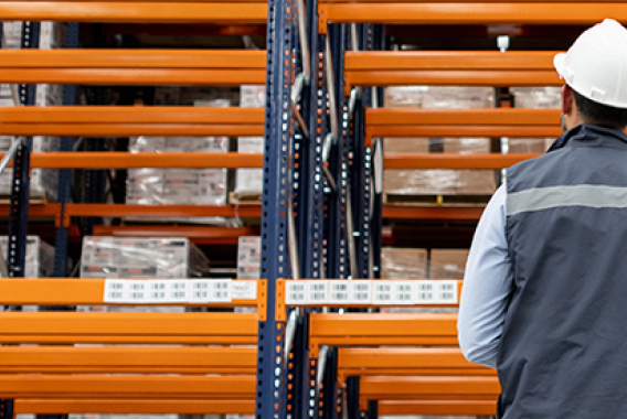 Worker looking at warehouse racking systems.