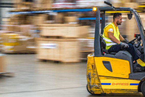 Man speeding in a yellow forklift