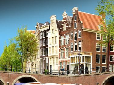 Buildings and a boat on a canal in Amsterdam