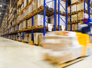 Blurred yellow forklift in a warehouse